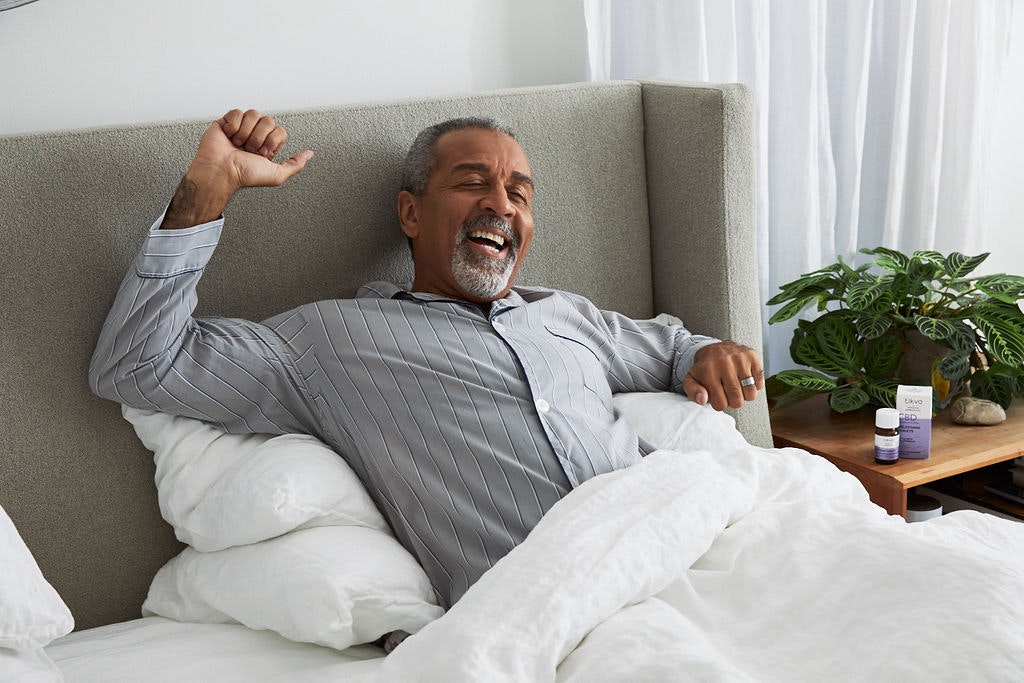 Man waking up after melatonin tablets helped with a good night's rest