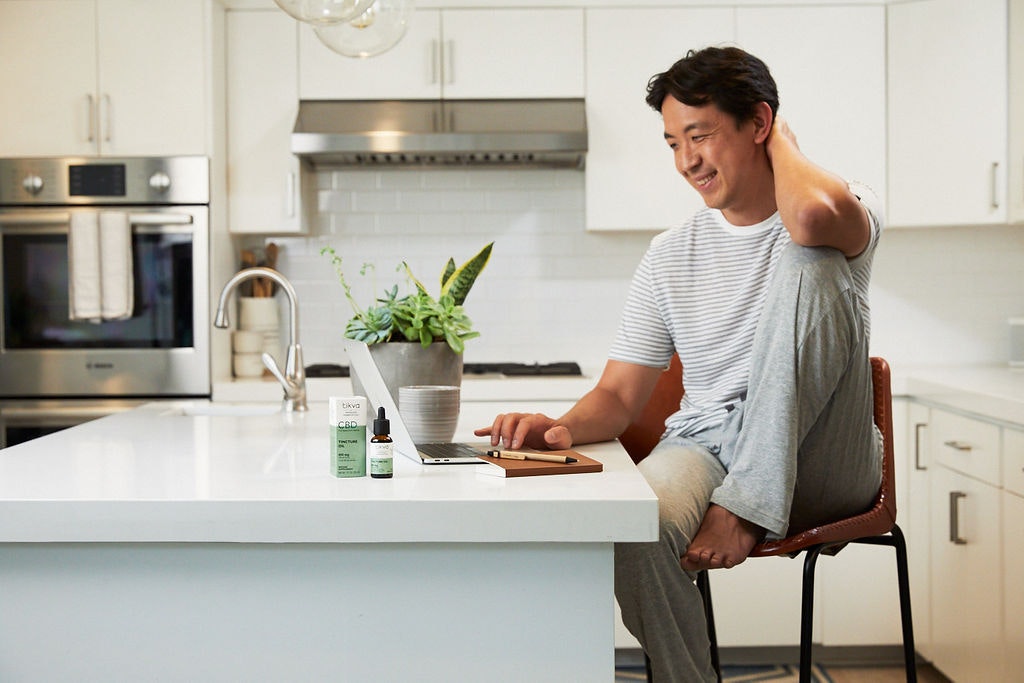 Man working at home office with Tincture Oil